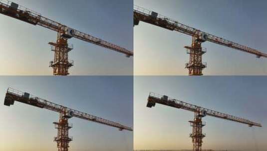 夕阳下航拍建筑工地上的塔吊高清在线视频素材下载