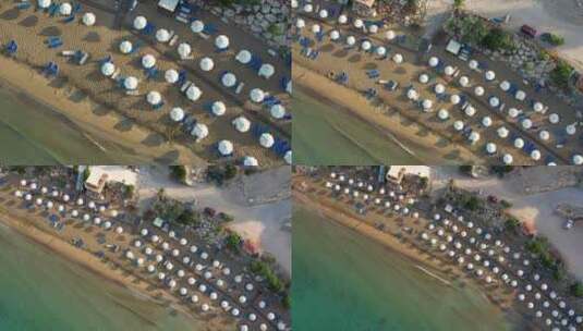 自上而下的空中放大塞浦路斯海滩的床和雨伞高清在线视频素材下载