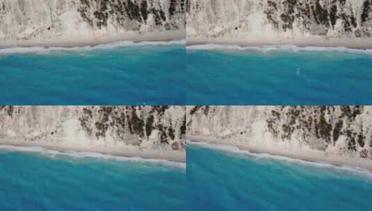 海浪撞击爱奥尼亚岛莱夫卡达埃格雷姆尼海滩海岸线的鸟瞰图高清在线视频素材下载