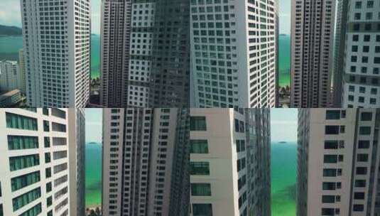 无人机穿过高层建筑到海面高清在线视频素材下载