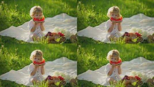 可爱的小女孩在吃西瓜做在草地上高清在线视频素材下载