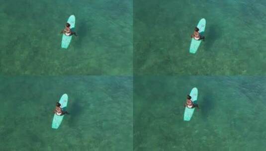 坐在海上冲浪板上的女人高清在线视频素材下载
