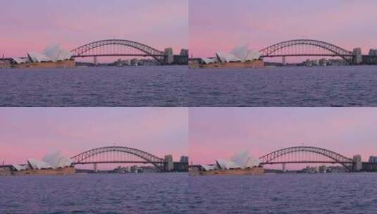 粉色天空下悉尼歌剧院和桥梁高清在线视频素材下载