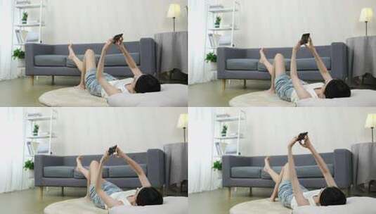 女子躺地玩手机居家场景高清在线视频素材下载