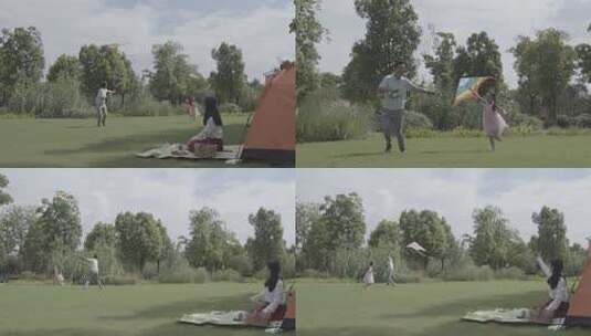 休闲欢乐温馨家人公园草地上露营放风筝高清在线视频素材下载