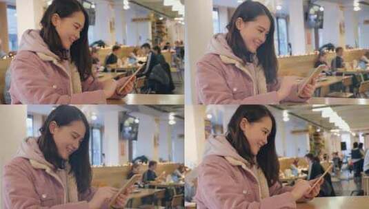 女留学生在学校餐厅使用手机高清在线视频素材下载