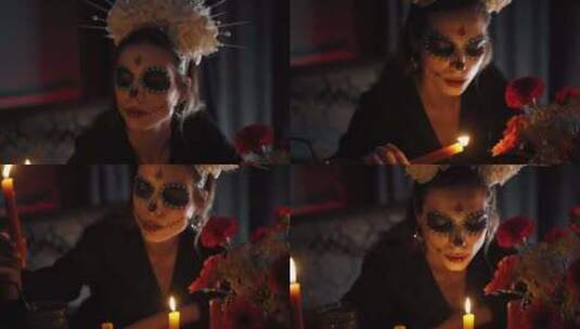 一个化着令人毛骨悚然的妆点燃蜡烛的女人高清在线视频素材下载