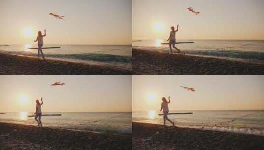 女人沿着海滩放风筝高清在线视频素材下载