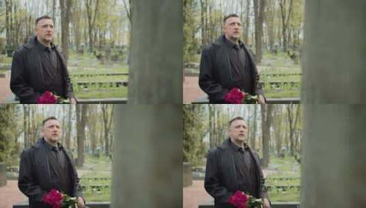 男人拿着玫瑰现在墓碑前高清在线视频素材下载