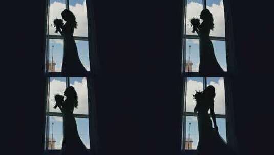 在窗前拿着花束的新娘剪影高清在线视频素材下载