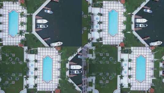 Birdeye鸟瞰，停靠的船，博卡度假村的游泳池和公园，高档公寓高清在线视频素材下载