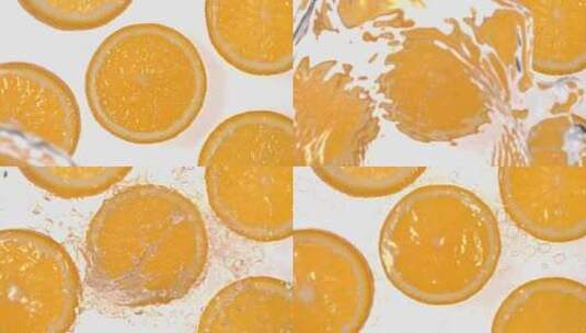 俯拍水泼向白背景上的橙子切片 4k慢镜头高清在线视频素材下载