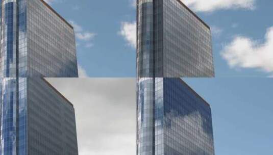 蓝天下的商业楼玻璃幕墙映照着白云流动高清在线视频素材下载