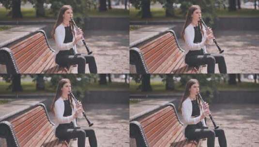 女孩在公园里吹单簧管高清在线视频素材下载