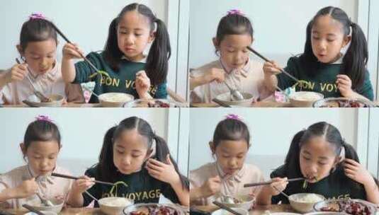 大口吃饭的两名中国女孩高清在线视频素材下载
