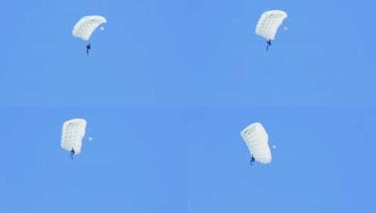 一名穿着白色降落伞的男子坠落高清在线视频素材下载