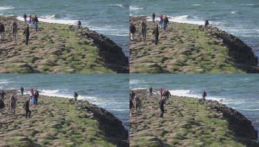 海岸巨石上的人们高清在线视频素材下载