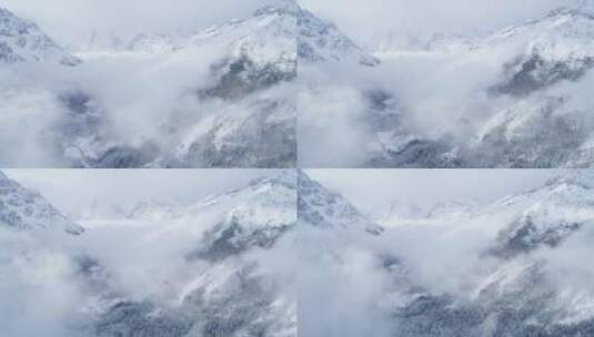 云雾缭绕雪山沟谷航拍冬季景观高清在线视频素材下载