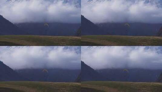雪山下滑滑翔伞的人高清在线视频素材下载