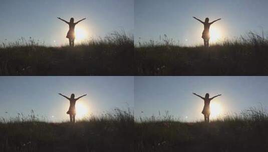 女孩站在日落的草地上高清在线视频素材下载