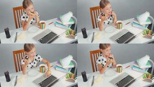 女孩吃着三明治看电脑高清在线视频素材下载