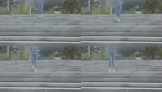穿着运动装公园台阶上跑步的年轻女性高清在线视频素材下载