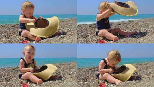 海滩上戴帽子的婴儿高清在线视频素材下载