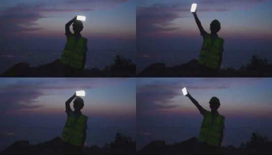 工程师拿着手机在夕阳下高清在线视频素材下载