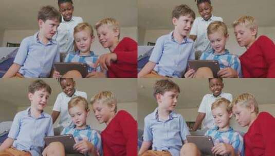 快乐多样化男孩在学校使用平板电脑的视频高清在线视频素材下载