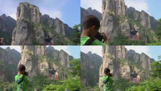 小男孩在眺望拍摄温州雁荡山灵峰景区北斗洞高清在线视频素材下载