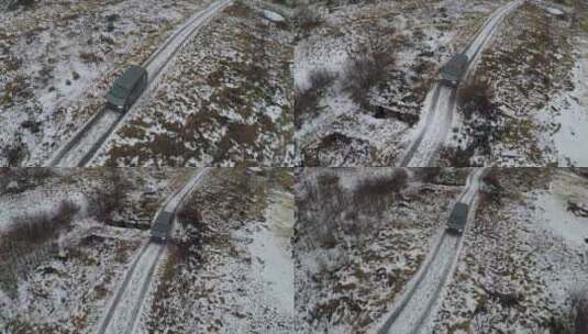 黑色货车沿着积雪覆盖的道路天线行驶高清在线视频素材下载