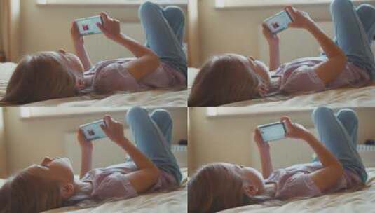 女孩躺在床上看手机高清在线视频素材下载
