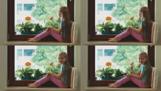 女孩坐在窗台上看着窗外高清在线视频素材下载