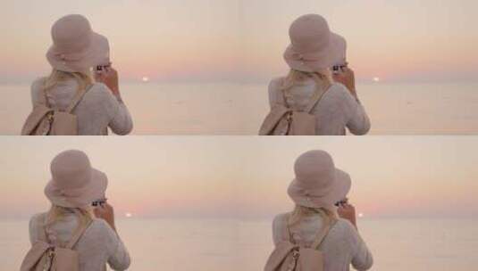 黄昏女人拍摄海边日落风景高清在线视频素材下载