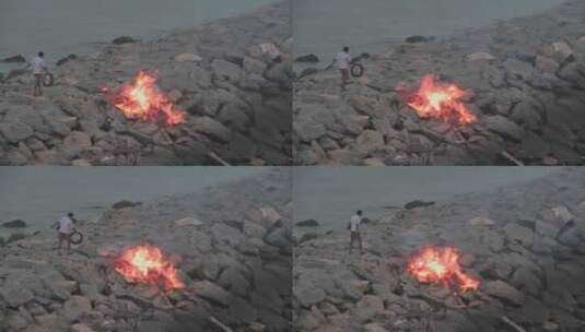 男人把垃圾扔进燃烧的火里高清在线视频素材下载