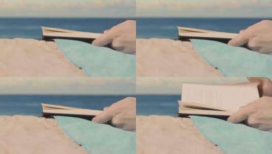 在沙滩上翻阅书籍的手微距场景高清在线视频素材下载