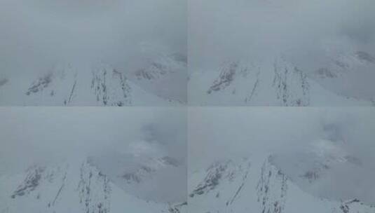 航拍四川阿坝松潘岷山山脉云雾中的雪山高清在线视频素材下载
