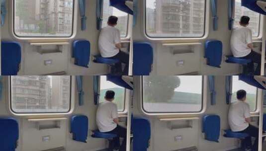 行驶中火车窗外的城市座椅上的背影高清在线视频素材下载