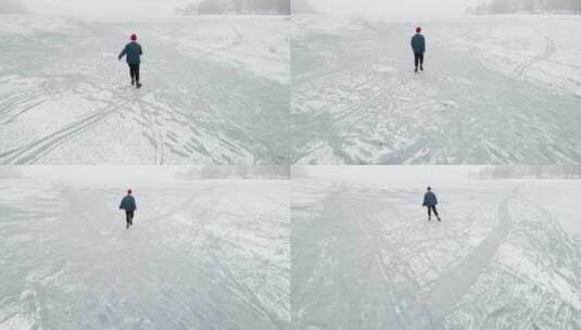 男人在结冰的湖面溜冰高清在线视频素材下载