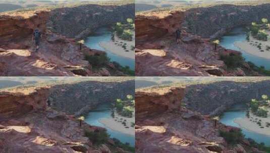 一个人远足，消失在峡谷上的黄褐色悬崖周围高清在线视频素材下载
