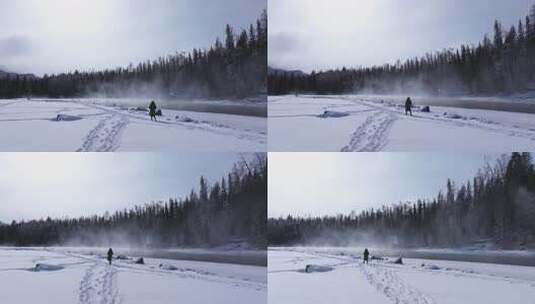 航拍新疆阿勒泰冬季喀纳斯游客在雪地上游玩高清在线视频素材下载