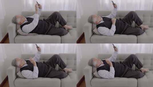 老人躺沙发上玩手机高清在线视频素材下载