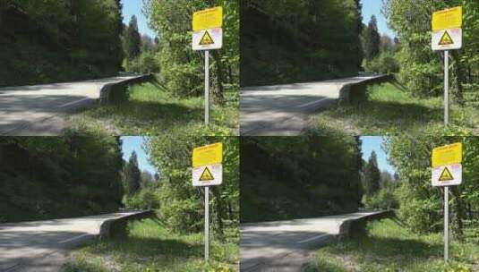森林山路旁的公路危险标志特写高清在线视频素材下载