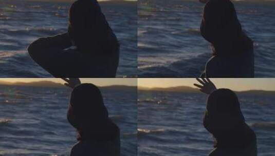 黄昏时分女孩在拉昂错湖边面对着夕阳高清在线视频素材下载