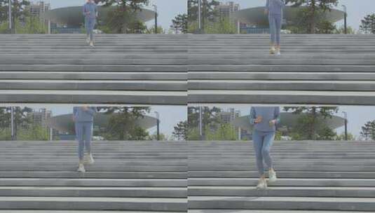 穿着运动装公园台阶上跑步的年轻女性高清在线视频素材下载