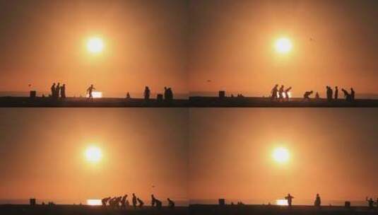 日落时分，圣莫尼卡海滩上，十几岁的男孩在踢美式足球。高清在线视频素材下载