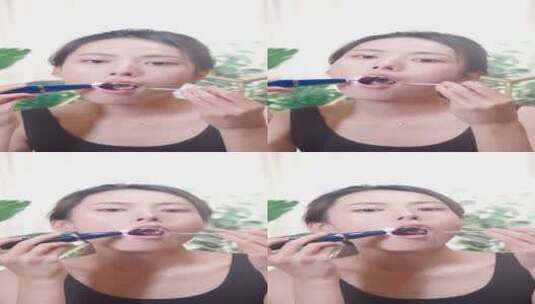 在室内家中使用洁牙仪清理口腔的年轻女孩高清在线视频素材下载