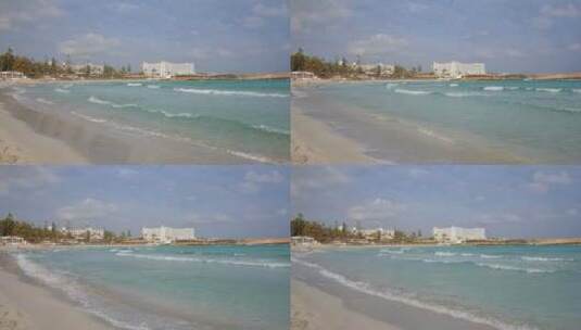白天塞浦路斯著名的尼西海滩的强大绿松石波浪高清在线视频素材下载