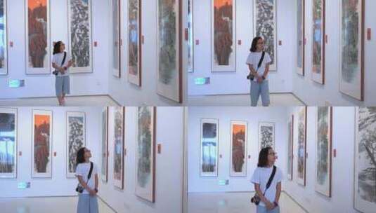 4K升格实拍在艺术馆参观欣赏画展的女孩高清在线视频素材下载