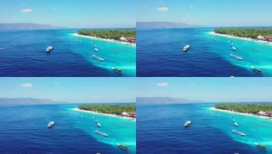 停泊在蓝色蓝色泻湖上的旅游船，靠近位于热带岛屿海岸的度假胜地，白色高清在线视频素材下载